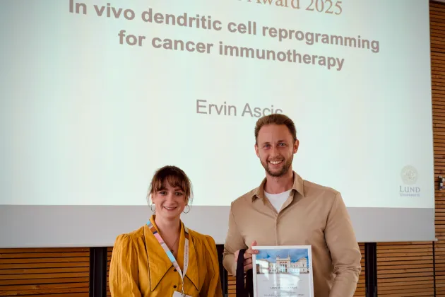 Photo of Ervin Ascic (right) and a representative from the Annual Meeting organizing committee (left).