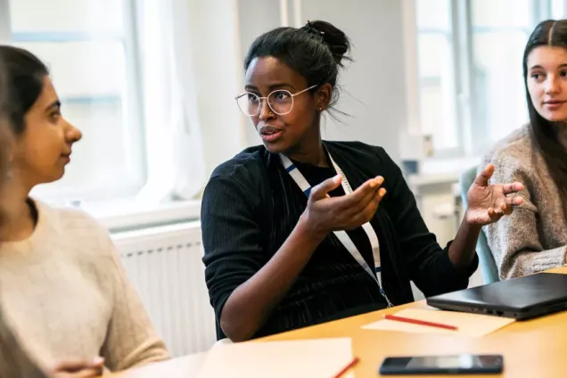 Students in conversation at a table.