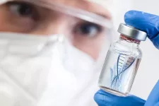 iStock Photo. Stock photo of a person holding a medicine vial with a graphical representation of DNA inside the vial.
